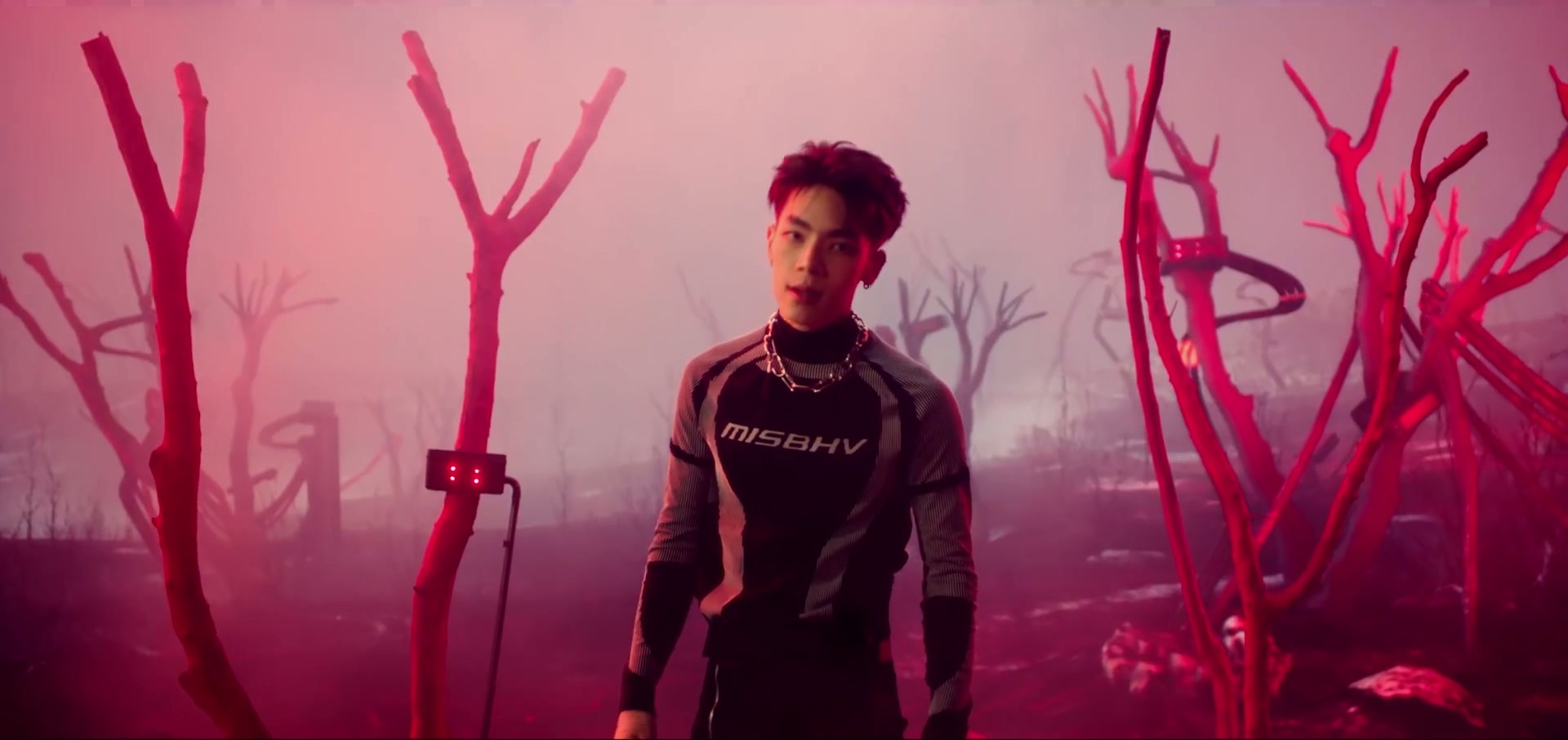 ATLAS performer among red-lit branches in the finished MAYDAY MAYDAY music video