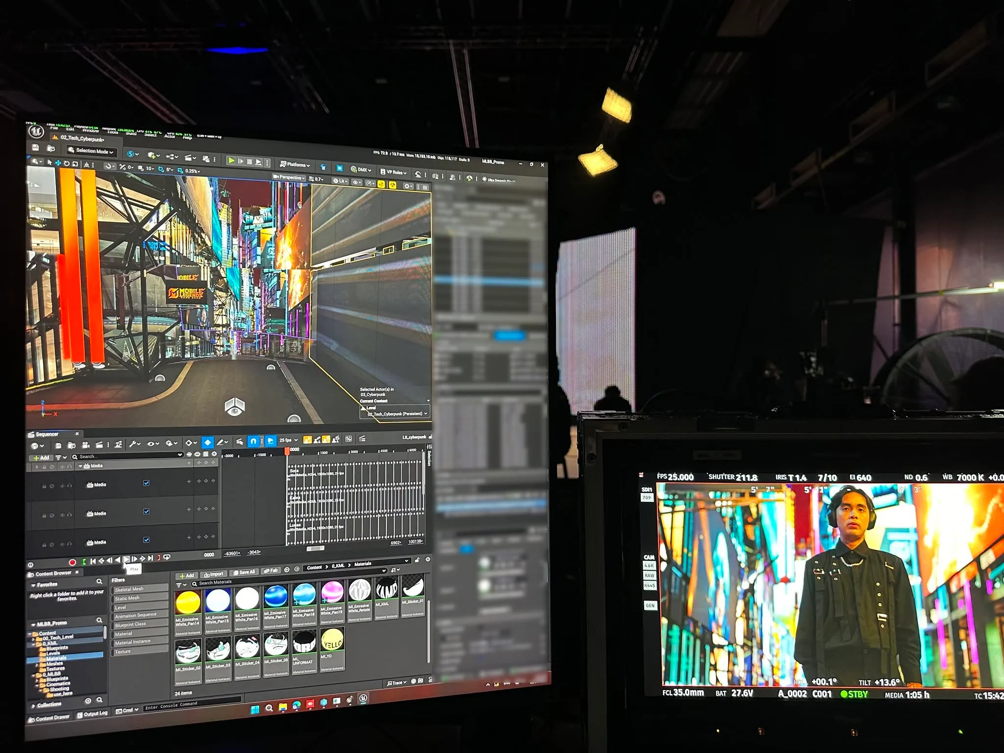 Unreal city environment on a workstation beside a camera monitor showing Guyngid on set.