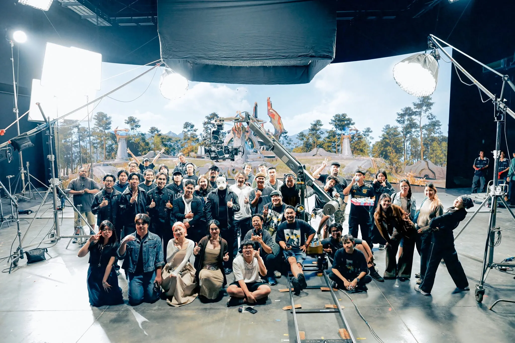 The MLBB x Guyngid production team in front of the LED volume displaying the game landscape.