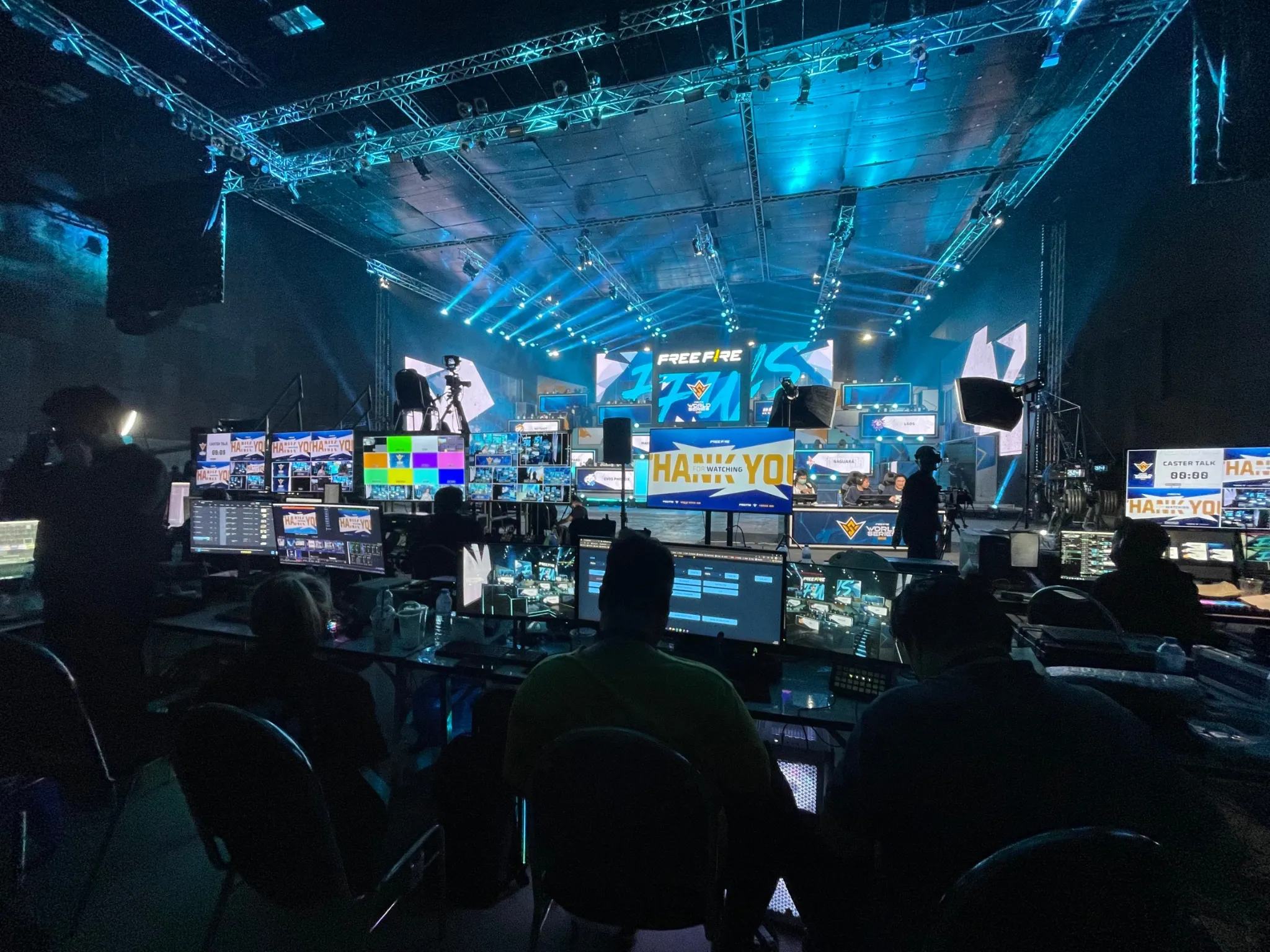 Broadcast crew at rows of monitors facing the stage at Free Fire World Series 2023 Bangkok
