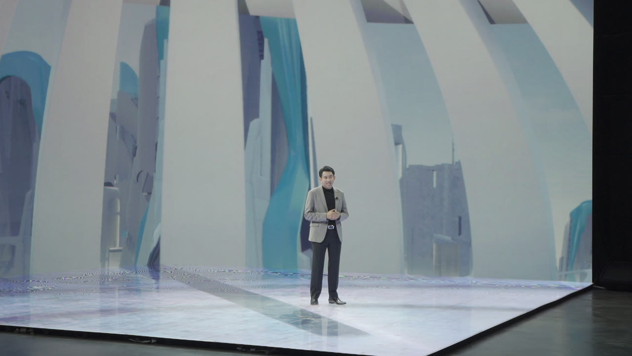 Presenter standing on the illuminated LED stage during Kubota virtual production.
